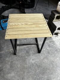Small slatted wood table with metal legs Small wooden slatted table on metal legs